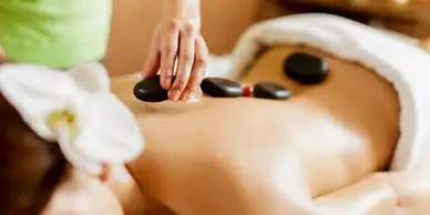 A person is getting a hot stone massage.