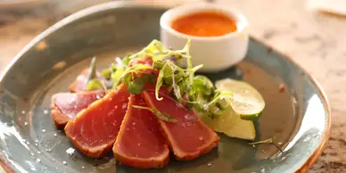 A plate of food with meat and sauce.